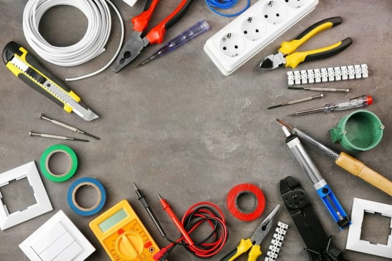 A table showcasing various electrical tools such as pliers, screwdrivers, and wire cutters, all arranged for easy access.